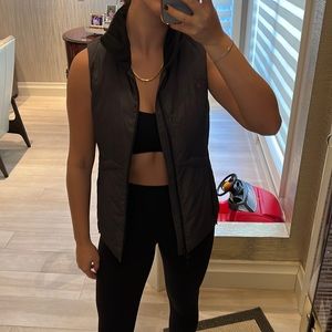 Dark grey puffer vest. Thin and light. Black fur collar. Great condition